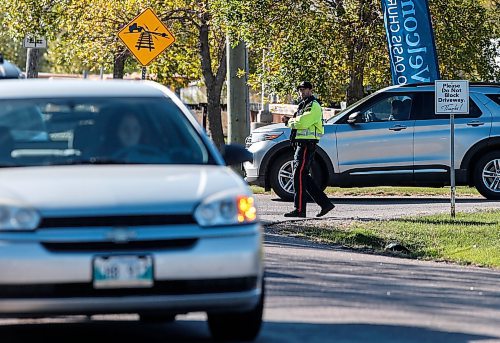 JOHN WOODS / FREE PRESS
A police officer directs traffic on Elmhurst at Wilkes Sunday, October 6, 2024. The Oasis Church on Elmhurst requires two city cops to direct traffic before and after their services.

Reporter: