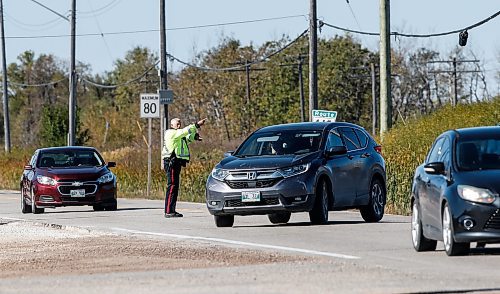 JOHN WOODS / FREE PRESS
A police officer directs traffic on Wilkes at Elmhurst Sunday, October 6, 2024. The Oasis Church on Elmhurst requires two city cops to direct traffic before and after their services.

Reporter: