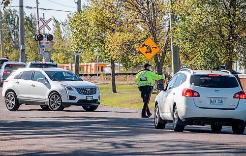 JOHN WOODS / FREE PRESS
A police officer directs traffic on Elmhurst at Wilkes Sunday, October 6, 2024. The Oasis Church on Elmhurst requires two city cops to direct traffic before and after their services.

Reporter: