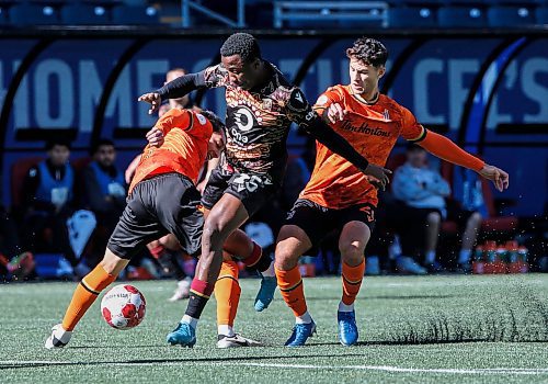 JOHN WOODS / WINNIPEG FREE PRESS
Valour FC&#x573; Loc Kwemi (25) breaks through the defence of Forge FC&#x573; Daniel Parra (17) and Alessandro Hojabrpour (21) during first half Canadian Premier League action in Winnipeg Sunday, October 6, 2024. 

Reporter: ?