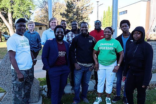 Brandon Mayor Jeff Fawcett and some members of the city's Nigerian community stand for a picture after the flag-raising event at city hall on Monday morning. (Abiola Odutola/The Brandon Sun)