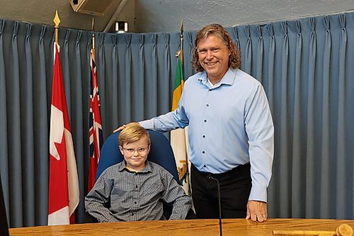 Frasier McArthur sits in the mayor's chair in the Brandon City Council Chamber on Monday with Mayor Jeff Fawcett at his side. The nine-year-old from École New Era School served as Brandon’s "Mayor for a Day," a position he has been dreaming of for more than a year. “I feel happy and looking forward to sharing my experience with my friends in school tomorrow,” he said. Fawcett praised the boy’s passion and initiative, noting their year-long relationship that began when Frasier wrote letters to him requesting to be the mayor of the city for one day. (Abiola Odutola/The Brandon Sun)