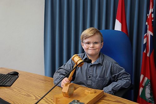 Frasier McArthur holds the mayor's gavel in the Brandon City Council Chamber on Monday. The nine-year-old from École New Era School served as Brandon’s "Mayor for a Day," a position he has been dreaming of for more than a year. “I feel happy and looking forward to sharing my experience with my friends in school tomorrow,” he said. Fawcett praised the boy’s passion and initiative, noting their year-long relationship, which began when Frasier wrote letters to him requesting to be the mayor of the city for one day. (Abiola Odutola/The Brandon Sun)