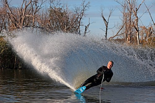 Daryl Makinson with the Brandon Waterski Club carves up a wave of water while slalom skiing on the Assiniboine River in Brandon on a warm and sunny Monday evening. (Tim Smith/The Brandon Sun)