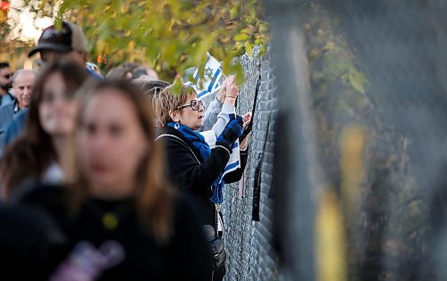 JOHN WOODS / WINNIPEG FREE PRESS
People pin ribbons with victim names, attend a walk and memorial in support of victims of Oct 7  in Winnipeg Monday, October 7, 2024. 

Reporter: ?