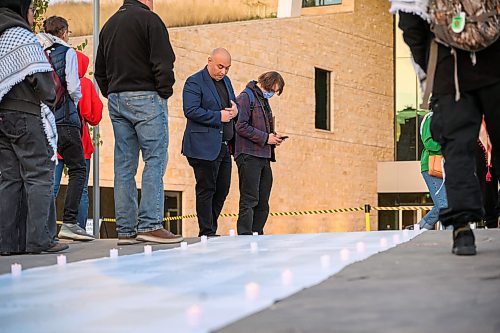 Mike Sudoma/Free Press
Pro Palestinian supporters take a moment to read the long list of names of people under the age of 18 who fell casualty to the Gaza conflict one year ago today 
October 7, 2024
