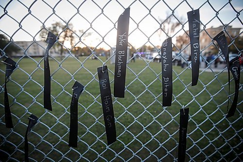 JOHN WOODS / WINNIPEG FREE PRESS
People pin ribbons with victim names, attend a walk and memorial in support of victims of Oct 7  in Winnipeg Monday, October 7, 2024. 

Reporter: ?