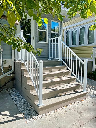 Marc LaBossiere / Free Press
White aluminum railings tie-in the soffits, cladding and troughs chosen by the homeowner, while white decorative stone fills the gaps in concrete along the porch base.