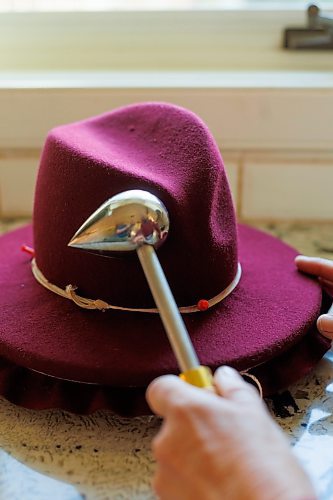 MIKE DEAL / FREE PRESS
Kelly Bekeris, Milliner, shows how she uses her egg iron on a fedora hat that is under construction.
When Kelly Bekeris retired from teaching, she found herself with plenty of time on her hands. Already an accomplished seamstress, she started making mittens, from merino wool which she sourced from vintage jumpers. Deciding to challenge herself even further, the 72-year-old ventured into millinery. She&#x2019;s yet-to-regret that decision and has made around 300 hats since she started in 2019. 
Reporter: AV Kitching
241009 - Wednesday, October 09, 2024.