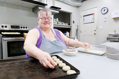 MIKE DEAL / FREE PRESS
Deb takes little balls of dough and adds the filing.
Deb Rogalsky, founder of Deb's Meat Buns, runs her home-based enterprise out of a commercial kitchen attached to her home in Landmark, Manitoba. 
She bakes as many as 300 dozen meat buns a week.
She turns out over a dozen varieties of meat buns, or perishky, including pulled pork, buffalo chicken and taco - as well as one called the Original (ground beef, onions, mashed potatoes) based on a recipe developed by Deb's mom, decades ago. 
Reporter: Dave Sanderson
241009 - Wednesday, October 09, 2024.