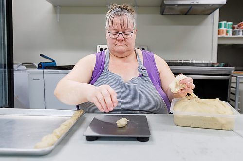 MIKE DEAL / FREE PRESS
Deb fills a tray with little balls of dough that she weighs individually. As he children grew up, they often dreamed of this part of the process being automated.
Deb Rogalsky, founder of Deb's Meat Buns, runs her home-based enterprise out of a commercial kitchen attached to her home in Landmark, Manitoba. 
She bakes as many as 300 dozen meat buns a week.
She turns out over a dozen varieties of meat buns, or perishky, including pulled pork, buffalo chicken and taco - as well as one called the Original (ground beef, onions, mashed potatoes) based on a recipe developed by Deb's mom, decades ago. 
Reporter: Dave Sanderson
241009 - Wednesday, October 09, 2024.