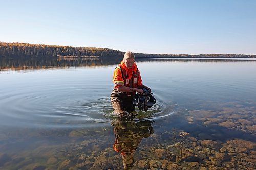 09102024
Caitlyn Stevenson, a Resource Management Technician with Parks Canada, carefully carries an underwater remote operated vehicle out of Clear Lake while inspecting a water-intake area used for the Clear Lake Golf Course with colleagues at Riding Mountain National Park on Wednesday. The technicians were conducting a general inspection as well as looking for evidence of zebra mussels and training some of technicians on operation of the ROV. The ROV is on loan to the park from the Parks Canada Archaeology branch. 
(Tim Smith/The Brandon Sun)