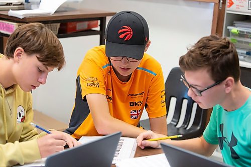 BROOK JONES / FREE PRESS
Grade 8 STEM Option students Ty Mitchell (middle), Xavier Lamb (left) and Nolan Grantham (right) are pictured looking over the mission goals and problem solving sheets at &#xc9;cole Stonewall Centennial School in Stonewall, Man., Thursday, Oct. 10, 2024. STEM 8 Option students particpate in the Canadian Space Agency's Rover Driving Academy with the company's mission control. Student teams were able to command via a remote computer accesss program a rover on a simulated lunar surface that the Canaidan Space Agency is developing in Longueil, Que., to go to the moon's surface.