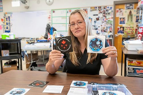 BROOK JONES / FREE PRESS
Grade 7 and 8 science, technology, engineering and math teacher Maria Nickel is pictured organizing spaceflight mission patches she has collected. The 54-year-old, who was pictured at &#xc9;cole Stonewall Centennial School in Stonewall, Man., Thursday, Oct. 10, 2024, teaches STEM 8 Option students about the Canadian Space Agency's Rover Driving Academy with the company's mission control. Student teams were able to command via a remote computer accesss program a rover on a simulated lunar surface that the Canaidan Space Agency is developing in Longueil, Que., to go to the moon's surface.