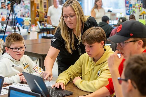 BROOK JONES / FREE PRESS
Teacher Maria Nickel, 54, is pictured helping Grade 8 STEM Option students (from left) Dominic Guerreiro,  Xavier Lamb, Ty Mitchell and Nolan Grantham at &#xc9;cole Stonewall Centennial School in Stonewall, Man., Thursday, Oct. 10, 2024. STEM 8 Option students particpate in the Canadian Space Agency's Rover Driving Academy with the company's mission control. Student teams were able to command via a remote computer accesss program a rover on a simulated lunar surface that the Canaidan Space Agency is developing in Longueil, Que., to go to the moon's surface.