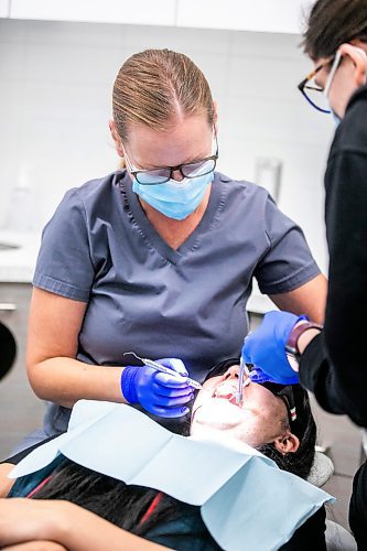 MIKAELA MACKENZIE / FREE PRESS
	
Dentist Carolyn Roberston (left) and dental assistant Kaylen Wallbridge demonstrate their craft on administrator Mameet Kaur at Harte Dental on Thursday, Oct. 10, 2024.

For AV story.
Winnipeg Free Press 2024