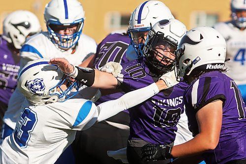 Quarterback Coleton Malyon of the Vincent Massey Vikings tries to break free from Elliot Falk of the River East Kodiaks while running the ball during WHSFL action at Doug Steeves Field on a beautiful Friday afternoon. (Tim Smith/The Brandon Sun)
