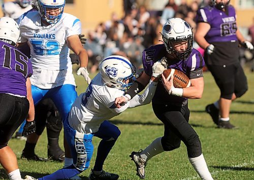 Quarterback Coleton Malyon of the Vincent Massey Vikings tries to break free from Elliot Falk of the River East Kodiaks while running the ball during high school varsity football action at Doug Steeves Field on Friday afternoon. Vincent Massey went on to win the game in a 31-3 rout of the Kodiaks. (Tim Smith/The Brandon Sun)