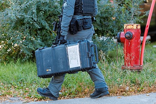 MIKE DEAL / FREE PRESS
Winnipeg Police Service tactical unit along with the armoured truck, drone operators and K9 units surround a house at 781 Flora Avenue to serve a search warrant early Friday morning. An ambulance and two Animal Services vans were on the scene as well.
241011 - Friday, October 11, 2024.