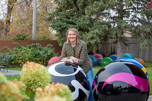 BROOK JONES/FREE PRESS
Erica Swendrowski is pictured with giant fibreglass marbles in her backyard in Winnipeg, Man., Thursday, Oct. 10, 2024. The local artist and landscape dsesigner is refurbishing the marbles she created as a public art piece dubbed Marbles at Mayfair which is a City of Winnipeg public art collection. Pictured in the backgroiund are bubbles she also created. Smiliar bubbles are located in the children's play area at the Victoria Hospital Miracle Garden.