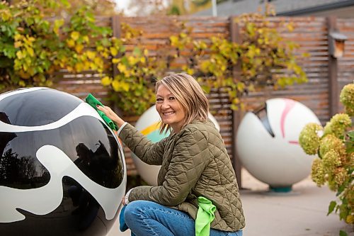 BROOK JONES/FREE PRESS
Erica Swendrowski smiles as she cleans a giant fibreglass marble sitting in her driveway in Winnipeg, Man., Thursday, Oct. 10, 2024. The local artist and landscape dsesigner is refurbishing the marbles she created as a public art piece dubbed Marbles at Mayfair which is a City of Winnipeg public art collection.