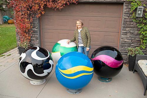 BROOK JONES/FREE PRESS
Erica Swendrowski is pictured with giant fibreglass marbles in her driveway in Winnipeg, Man., Thursday, Oct. 10, 2024. The local artist and landscape dsesigner is refurbishing the marbles she created as a public art piece dubbed Marbles at Mayfair which is a City of Winnipeg Public Art Collection.