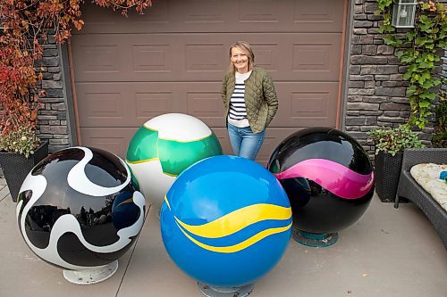 BROOK JONES/FREE PRESS
Erica Swendrowski is pictured with giant fibreglass marbles in her driveway in Winnipeg, Man., Thursday, Oct. 10, 2024. The local artist and landscape dsesigner is refurbishing the marbles she created as a public art piece dubbed Marbles at Mayfair which is a City of Winnipeg Public Art Collection.