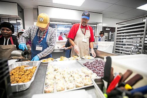 MIKAELA MACKENZIE / FREE PRESS
	
Volunteers Marc Lavallee (left) and Pat Harding serve up a Thanksgiving meal at Siloam Mission on Friday, Oct. 11, 2024.

Winnipeg Free Press 2024