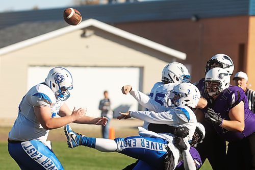 11102024
Quarterback Jackson Gardner #7 of the Vincent Massey Vikings throws a pass as he is hauled to the ground during high school varsity football action against the Vincent Massey Vikings at VMHS on a beautiful Friday afternoon. 
(Tim Smith/The Brandon Sun)