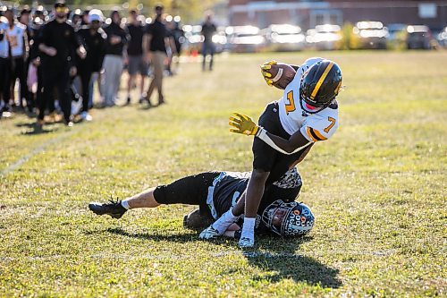 MIKAELA MACKENZIE / FREE PRESS
	
Dakota Lancer Seif Nasser (7) brings it home as Elmwood Giant Ryan Bride (55) attempts to stop him at Elmwood High School on Friday, Oct. 11, 2024.

For sports story.
Winnipeg Free Press 2024