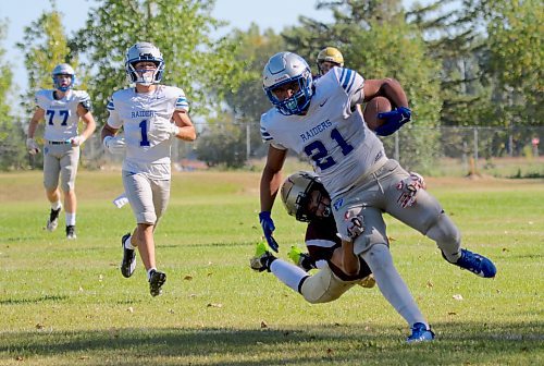 Crocus Plainsmen safety Simon Leckie dives to tackle Oak Park Raiders running back Onan Furst and save a touchdown in their Winnipeg High School Football League game at Crocus on Friday. (Thomas Friesen/The Brandon Sun)