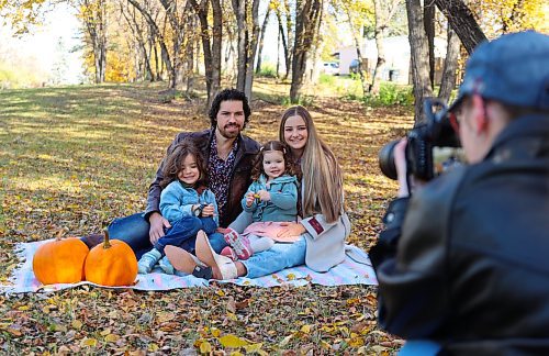 Chelsea Zaliska, her husband Vasyl Zaliskyy and their two children four-year-old Levi (front left) and two-year-old Rowa pose for photos taken by their cousin Paige Yanchycki on Thanksgiving Day in Brandon's west end. (Michele McDougall/The Brandon Sun)