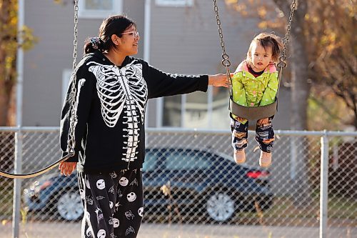 Mary Castel pushes her daughter Korra Welburn, almost 2, on a swing at the park across from the Park Community Centre in Brandon on a sunny Tuesday. (Tim Smith/The Brandon Sun)