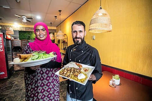 MIKAELA MACKENZIE / FREE PRESS
	
Sucad Mahamad with the lamb shank and rice (left) and Amer Alzubi with the chicken shawarma plate at Som Legacy Restaurant on Tuesday, Oct. 15, 2024.

For Eva story.
Winnipeg Free Press 2024