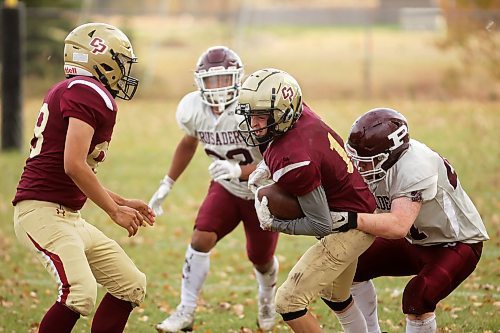 17102024
Quarterback Simon Leckie #11 of the Crocus Plainsmen runs the ball during high school football action against the St. Paul&#x2019;s Crusaders at CPRSS on a warm Thursday. 
(Tim Smith/The Brandon Sun)