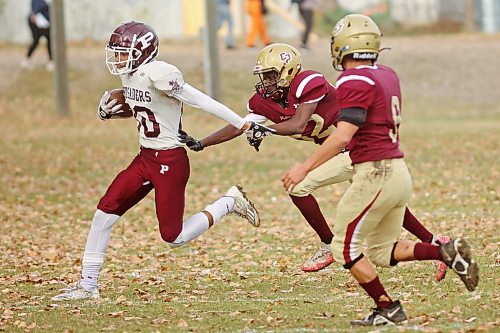 17102024
Emmanuel Adetoro #82 of the Crocus Plainsmen tries to pull down a St. Paul&#x2019;s Crusaders player during high school football action at CPRSS on a warm Thursday. 
(Tim Smith/The Brandon Sun)