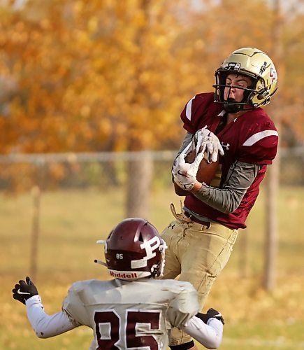 17102024
Quarterback Simon Leckie #11 of the Crocus Plainsmen catches the ball for an interception during high school football action against the St. Paul&#x2019;s Crusaders at CPRSS on a warm Thursday. 
(Tim Smith/The Brandon Sun)