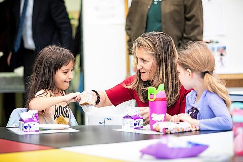 MIKAELA MACKENZIE / FREE PRESS
	
Deputy prime minister Chrystia Freeland hands kindergarten student Paloma Schembida a bannock snack at Marion School on Friday, Oct. 18, 2024.

For Maggie story.
Winnipeg Free Press 2024