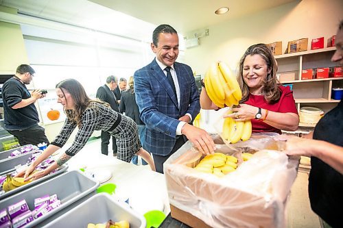 MIKAELA MACKENZIE / FREE PRESS
	
MLA Tracy Schmidt (left), deputy prime minister Chrystia Freeland, and premier Wab Kinew pack snack bins for Marion School classrooms on Friday, Oct. 18, 2024.

For Maggie story.
Winnipeg Free Press 2024