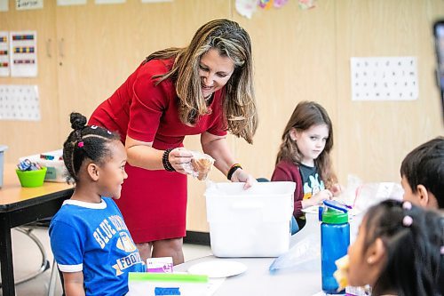 MIKAELA MACKENZIE / FREE PRESS
	
Deputy prime minister Chrystia Freeland hands kindergarten student Xena Turner a bannock snack at Marion School on Friday, Oct. 18, 2024.

For Maggie story.
Winnipeg Free Press 2024