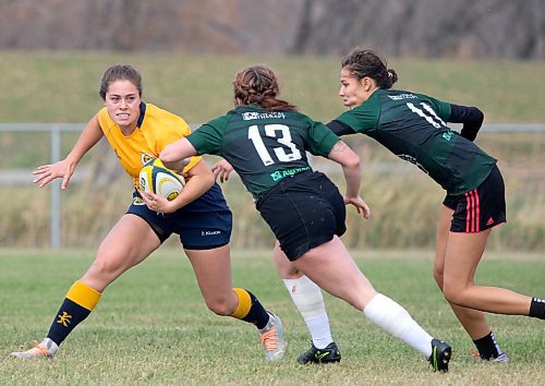 Brandon Bobcats Raegan Ricard jukes between a pair of University of Saskatchewan defenders during their Prairie University Women's Rugby Conference match at John Reilly Field on Saturday. Brandon won 107-7 to clinch a playoff spot. (Thomas Friesen/The Brandon Sun)