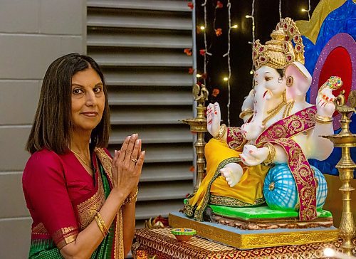 BROOK JONES/FREE PRESS
The Hindu Society of Manitoba hosts its annual Diwali Mela (Festival of Lights) at the RBC Convention Centre in Winnipeg, Man. Saturday, Oct. 19, 2024. Pictured: Bhawna Thakrar who is draped in a traditional sari prays in front of Lord Ganesha.