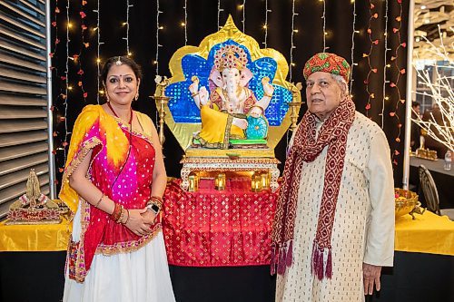 BROOK JONES/FREE PRESS
The Hindu Society of Manitoba hosts its annual Diwali Mela (Festival of Lights) at the RBC Convention Centre in Winnipeg, Man. Saturday, Oct. 19, 2024. Pictured: Shipra Verma (left) who is wearing a ghagra choli and Ganpat Lodla who is wearing a sherwani are pictured in front of Lord Ganesha.