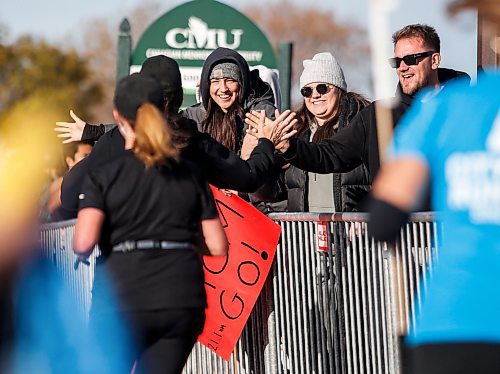 JOHN WOODS / FREE PRESS
Erica Alderson, left, and her sister Alyssa cheer on their mom Johanne Alderson with friend Willy Loewen as she finishes the WFPS Run at the Canadian Mennonite University Sunday, October 20, 2024. 

Reporter: s/u