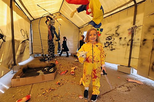 Young zombie Hannah Mitchell shows off the tunnel of terror in her family's Cedar Hollow haunted house on Sunday afternoon. (Colin Slark/The Brandon Sun)