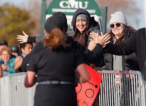 JOHN WOODS / FREE PRESS
Erica Alderson, left, and her sister Alyssa cheer on their mom Johanne Alderson with friend Willy Loewen as she finishes the WFPS Run at the Canadian Mennonite University Sunday, October 20, 2024. 

Reporter: s/u