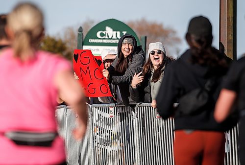 JOHN WOODS / FREE PRESS
Erica Alderson, left, and her sister Alyssa cheer on their mom Johanne Alderson, right, as she finishes the WFPS Run at the Canadian Mennonite University Sunday, October 20, 2024. 

Reporter: s/u