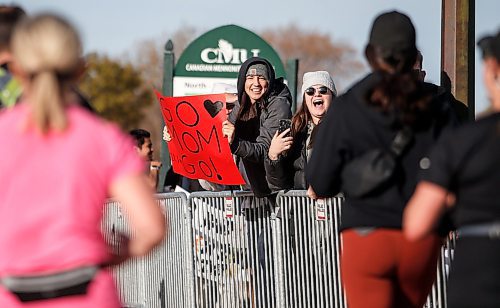 JOHN WOODS / FREE PRESS
Erica Alderson, left, and her sister Alyssa cheer on their mom Johanne Alderson, right, as she finishes the WFPS Run at the Canadian Mennonite University Sunday, October 20, 2024. 

Reporter: s/u