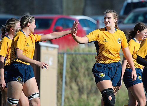 Eden Tabin, right, celebrates her first try as a Bobcat with Brooke Miner during a 107-7 victory over Saskatchewan. (Thomas Friesen/The Brandon Sun)