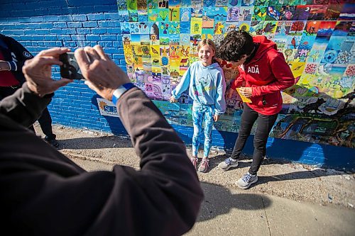 MIKAELA MACKENZIE / FREE PRESS
	
Allie Reinhardt (nine, left) and her grandmother Brenda Krueger take a photo with their painted tiles at the Canada Connects Love &amp; Family mosaic mural unveiling at 1797 Portage Avenue on Monday, Oct. 21, 2024.

For biz story.
Winnipeg Free Press 2024